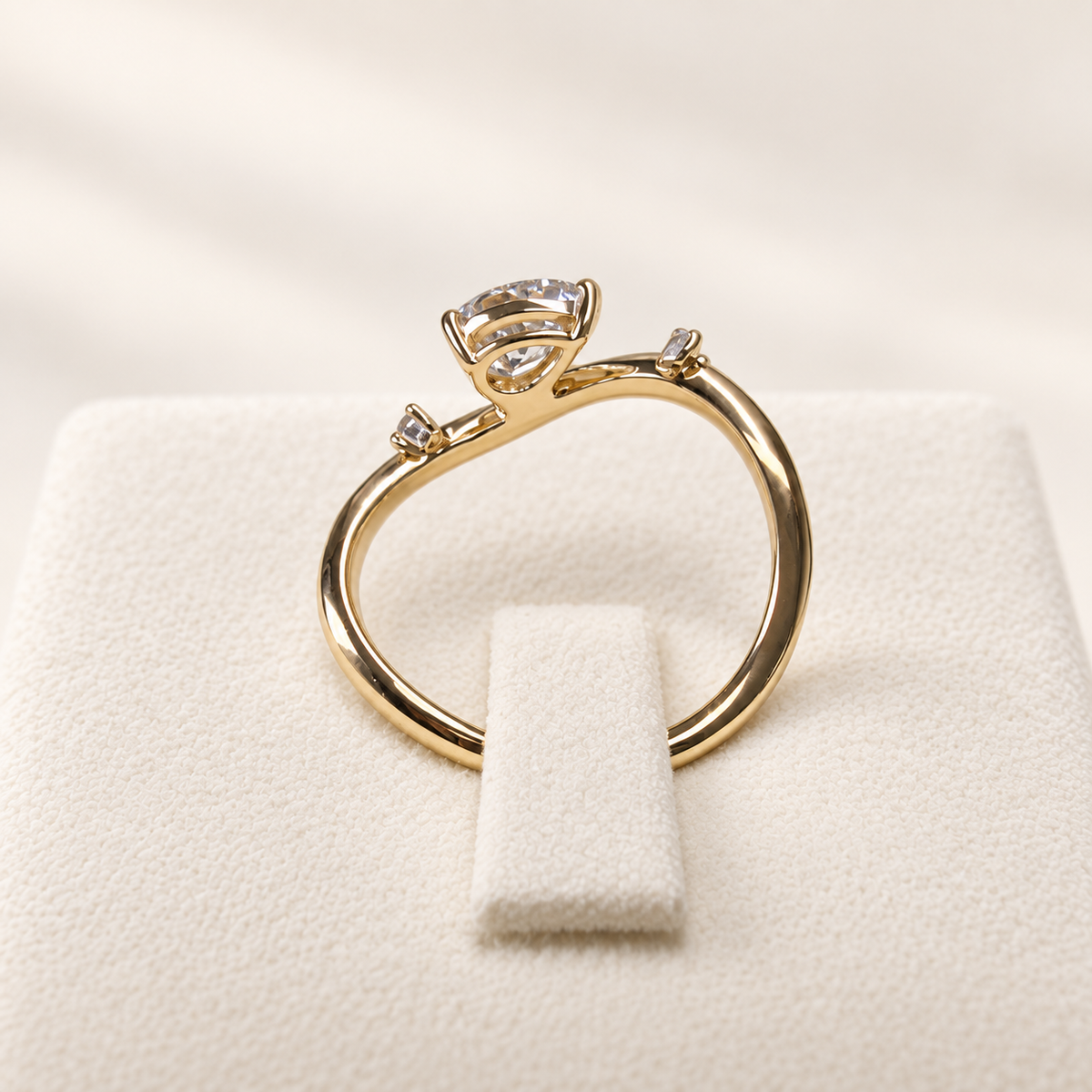 Arden Flame yellow gold pear diamond ring, rear setting view on ivory
