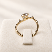 Arden Flame yellow gold pear diamond ring, rear setting view on ivory