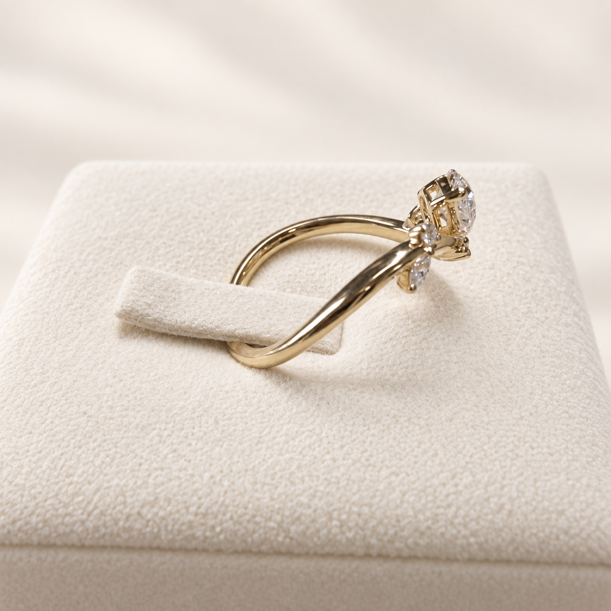 Arden Flame yellow gold pear diamond ring, side profile view on ivory