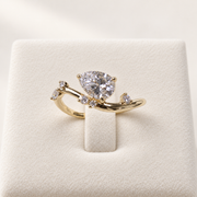 Arden Flame pear diamond ring in yellow gold, front view on an ivory display