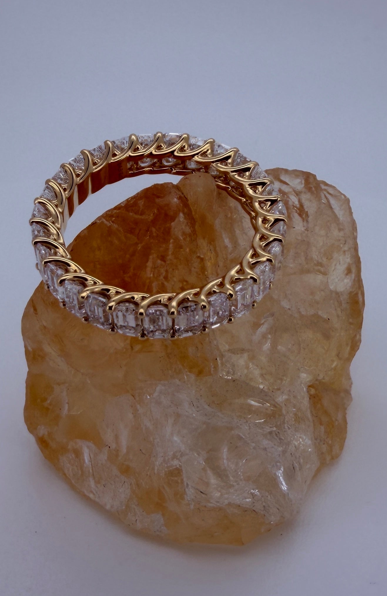 The Dominique 18K yellow gold emerald-cut diamond eternity ring — profile view