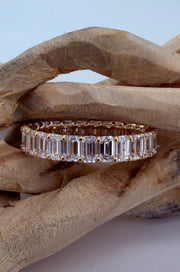 The Dominique 18K yellow gold emerald-cut diamond eternity ring — detail view