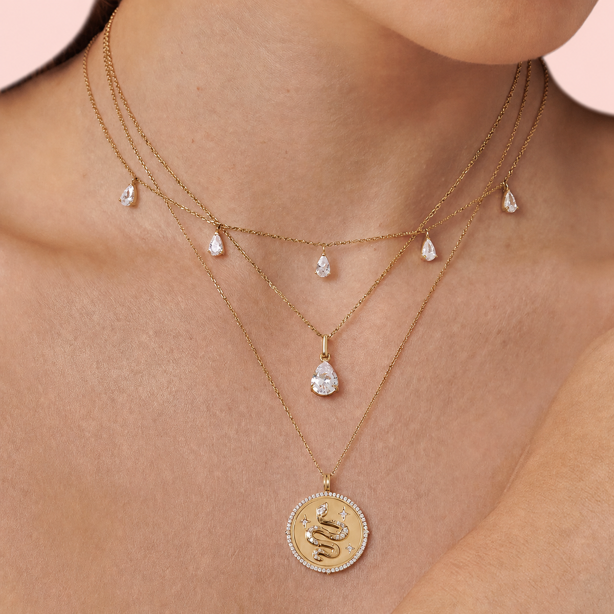 Aureline Crescent pear diamond necklace against a pale blush backdrop