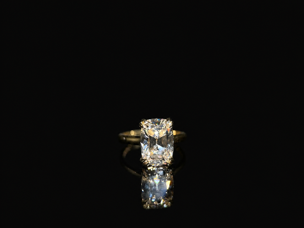 Isolde’s Secret elongated old-mine cushion laboratory-grown diamond ring, front view on polished black Perspex