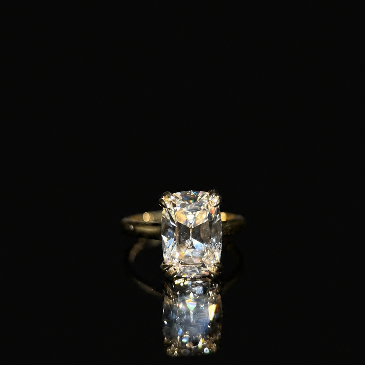 Isolde’s Secret elongated old-mine cushion lab-grown diamond ring, centred front view on polished black Perspex