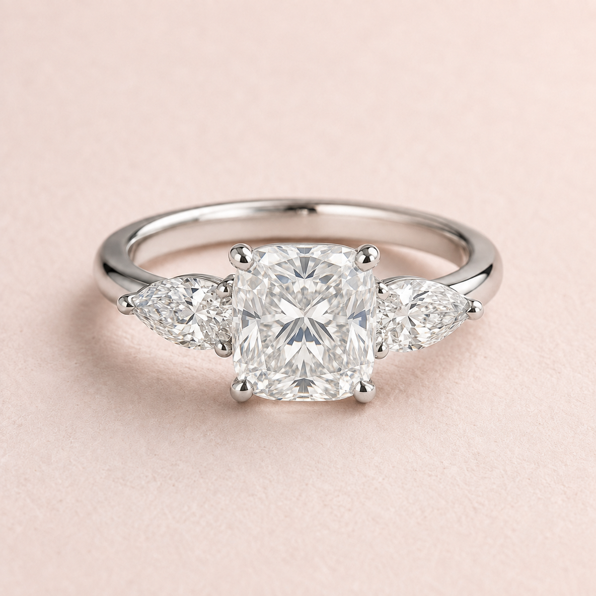 Lumera Passage three-stone ring concept with a cushion-cut centre and pear-shaped side stones in platinum