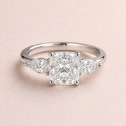 Lumera Passage three-stone ring concept with a cushion-cut centre and pear-shaped side stones in platinum