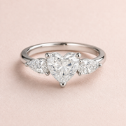 Lumera Passage three-stone ring concept with a heart-cut centre and pear-shaped side stones in platinum