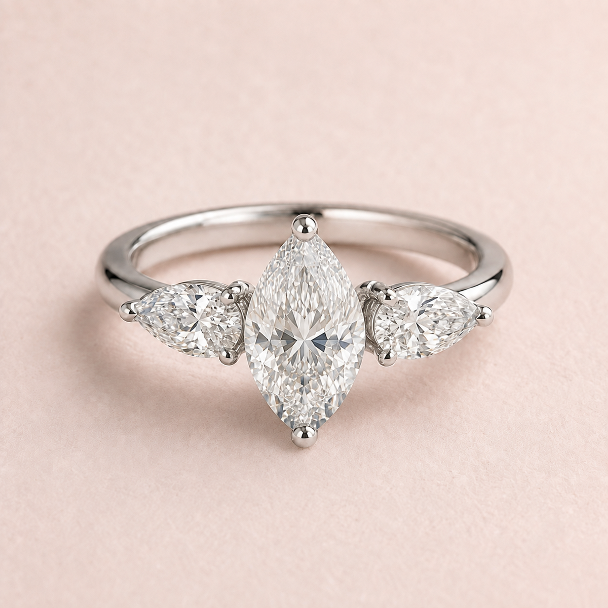 Lumera Passage three-stone ring concept with a marquise-cut centre and pear-shaped side stones in platinum
