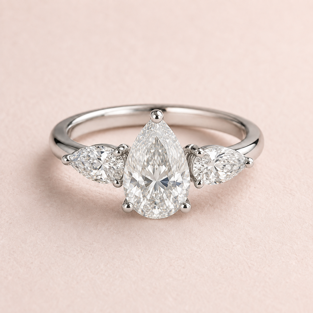 Lumera Passage three-stone ring concept with a pear-cut centre and pear-shaped side stones in platinum