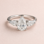 Lumera Passage three-stone ring concept with a pear-cut centre and pear-shaped side stones in platinum