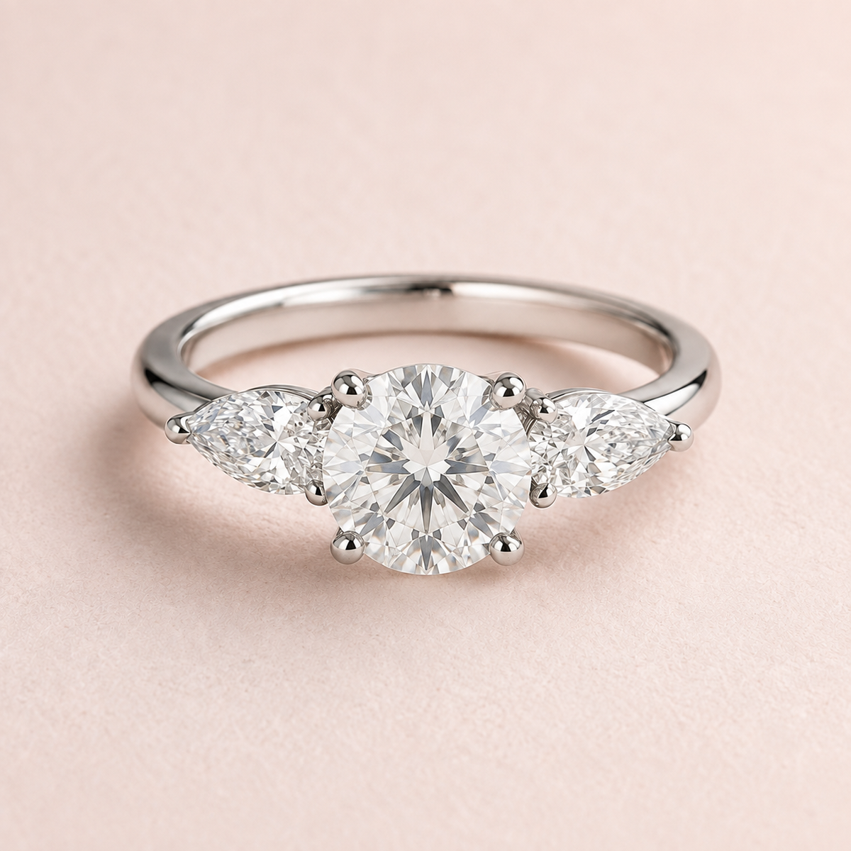 Lumera Passage three-stone ring concept with a round brilliant centre and pear-shaped side stones in platinum