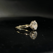 Olivia's Ovation lab-grown diamond ring in a three-quarter profile with its reflection on black Perspex