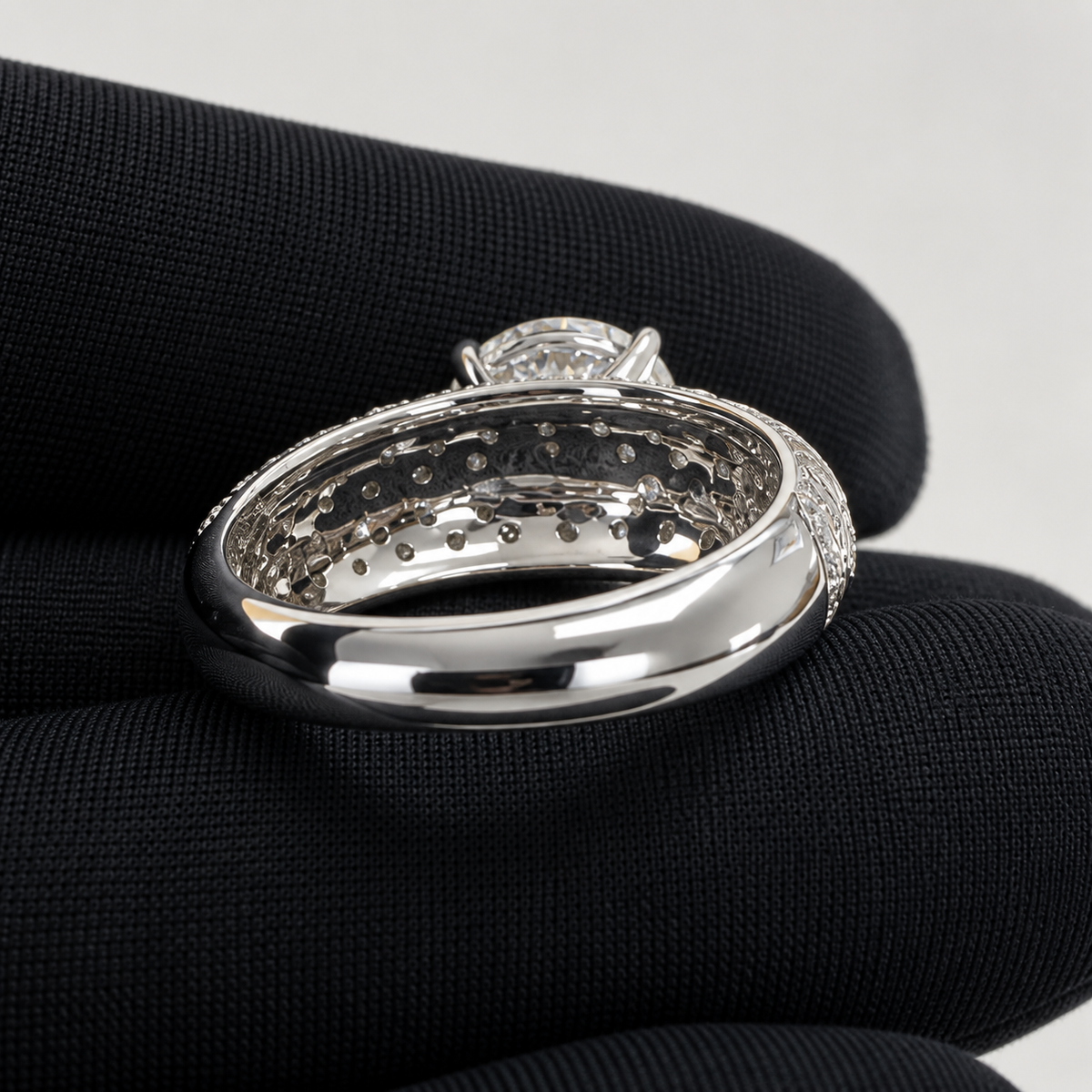 Plume — inner band and underside detail held in a black jeweller’s glove