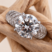 Plume — round centre and feathered pavé shoulders on natural driftwood