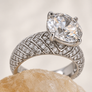 Plume — white-gold pavé shoulder detail on a softly toned crystal
