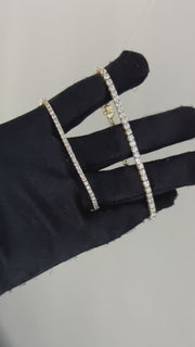 Eira Current tennis bracelets held together on a black-gloved hand
