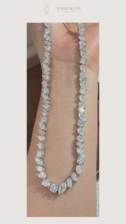 Eveline — Mixed-Shape Moissanite Necklace — original movement detail, muted, with Emberose paper framing.