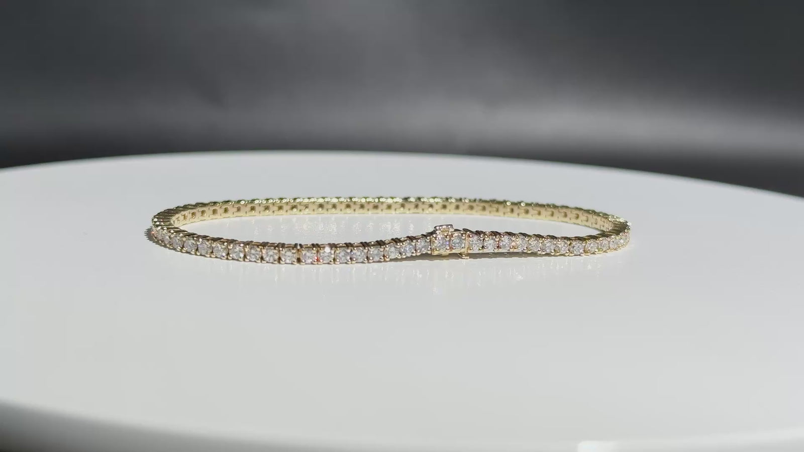 Eira Current tennis bracelet on a white turntable
