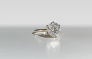Olivia's Ovation lab-grown diamond ring rotating on polished white Perspex