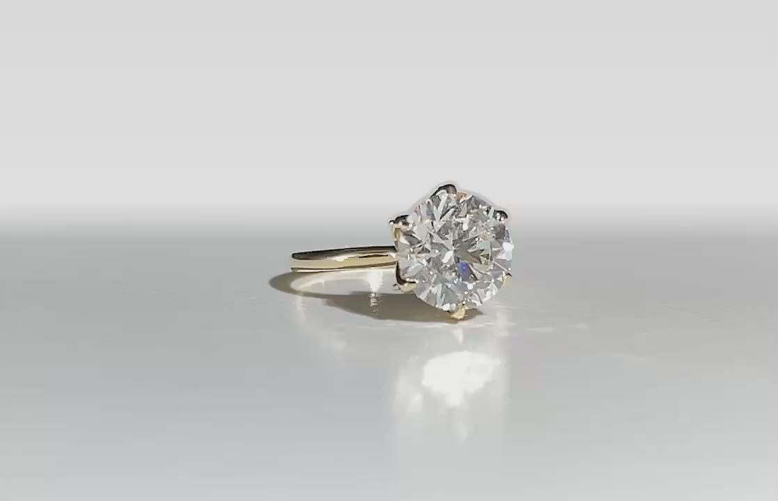 Olivia's Ovation lab-grown diamond ring rotating on polished white Perspex