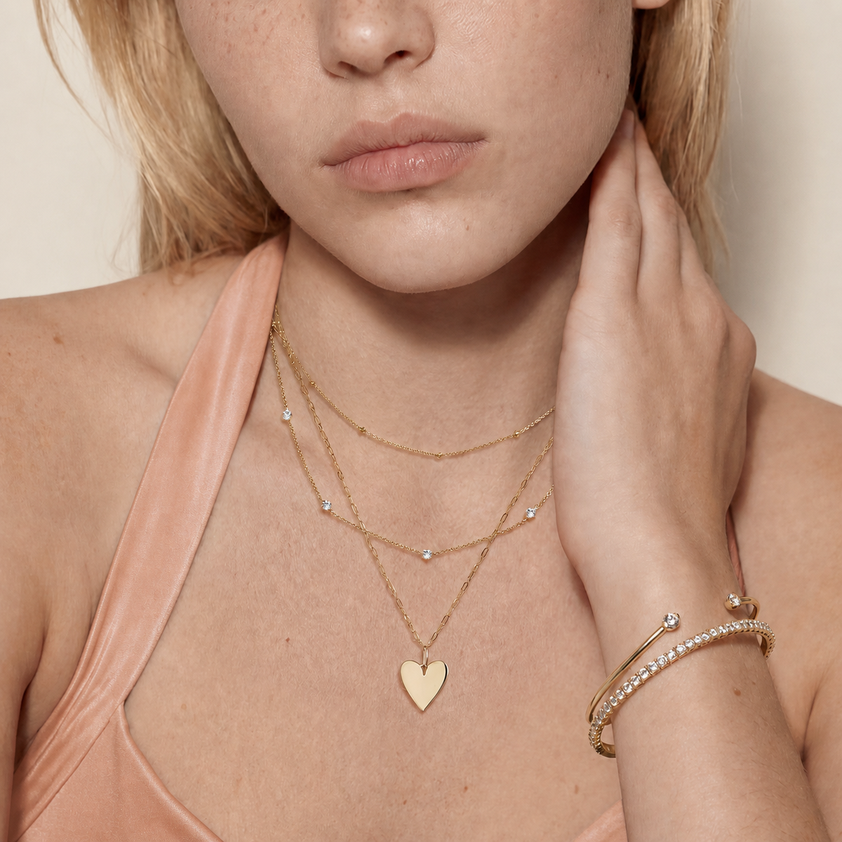 Roselle Still necklace styled with warm peach clothing