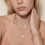 Roselle Still necklace styled with warm peach clothing