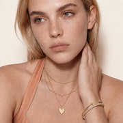 Roselle Still necklace styled with warm peach clothing
