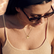 Roselle Still necklace styled with pale honey clothing