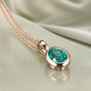 Verdant Heart green stone pendant on celadon satin
