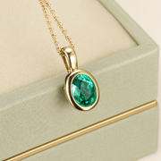 Verdant Heart green stone pendant on a pale sage presentation box