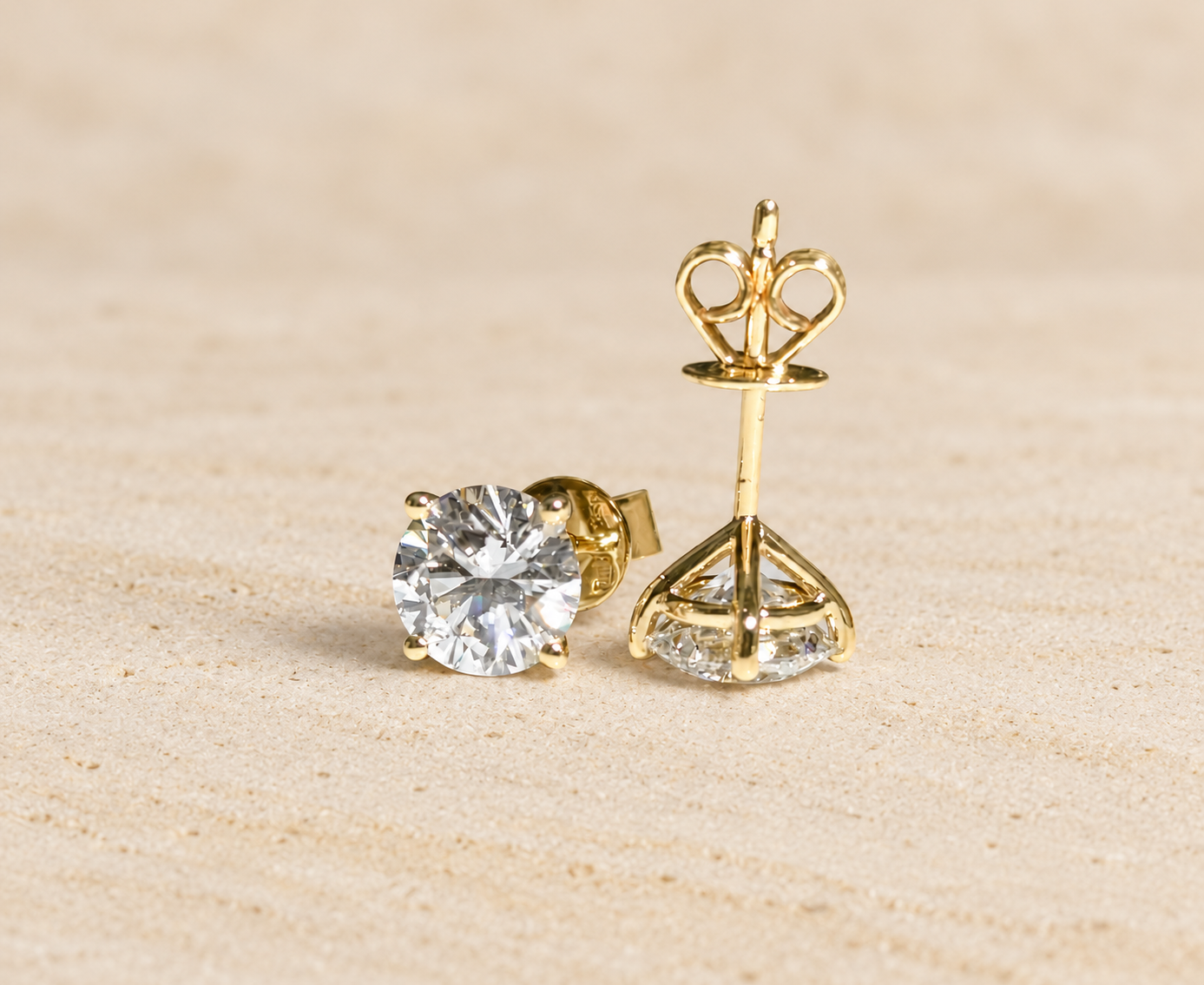 Liora Pair diamond studs on pale sandstone